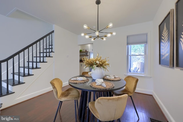 30 N Marshall St, Lancaster, PA 17602 - dining area with stairway, wood-type flooring, baseboards, visible vents, and a notable chandelier