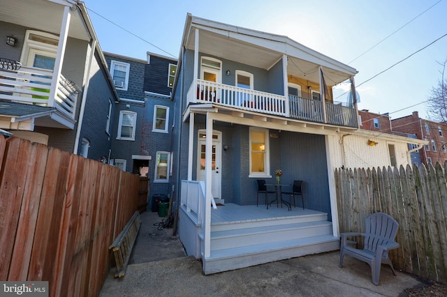 30 N Marshall St, Lancaster, PA 17602 - view of front of house with a balcony, a porch, fence, and brick siding