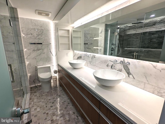 bathroom with a sink, a shower stall, and toilet