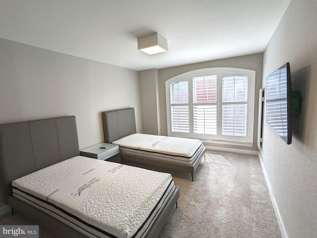 carpeted bedroom with baseboards