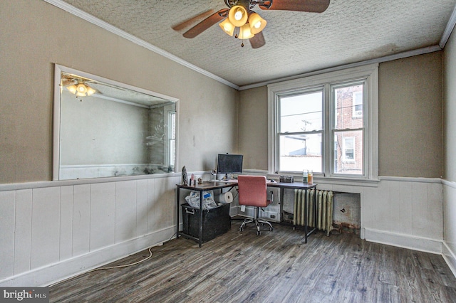 office space with a textured ceiling, wood finished floors, wainscoting, radiator heating unit, and crown molding