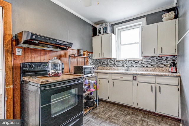 kitchen featuring stainless steel microwave, light countertops, under cabinet range hood, black range with electric cooktop, and a sink