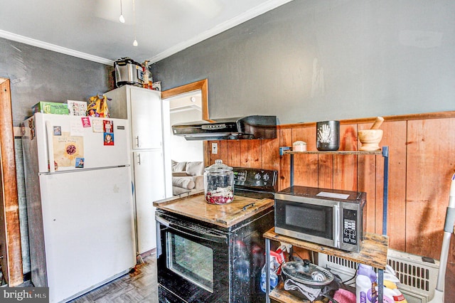 kitchen with stainless steel microwave, ornamental molding, freestanding refrigerator, black range with electric cooktop, and under cabinet range hood