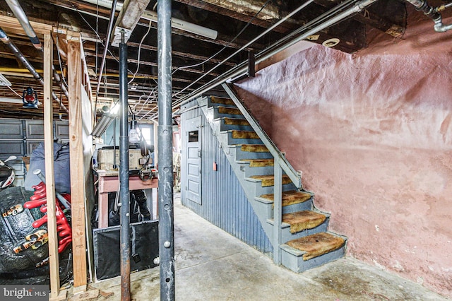 unfinished basement featuring stairway