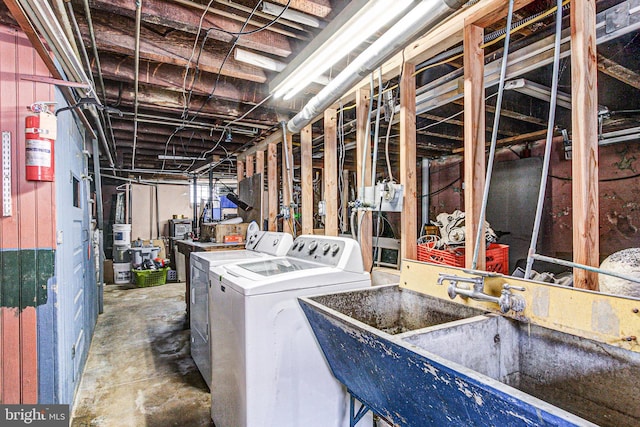 unfinished basement featuring a sink and washer and dryer