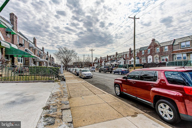 view of road featuring a residential view and sidewalks