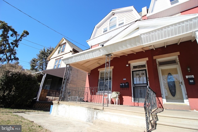 view of property featuring covered porch