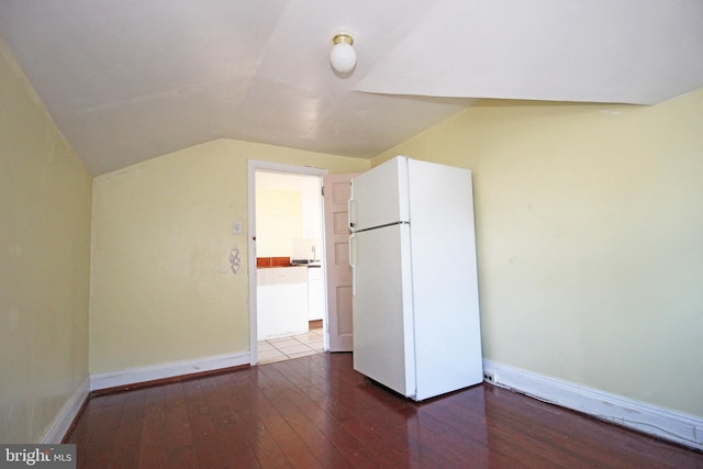 additional living space with vaulted ceiling, baseboards, and hardwood / wood-style flooring