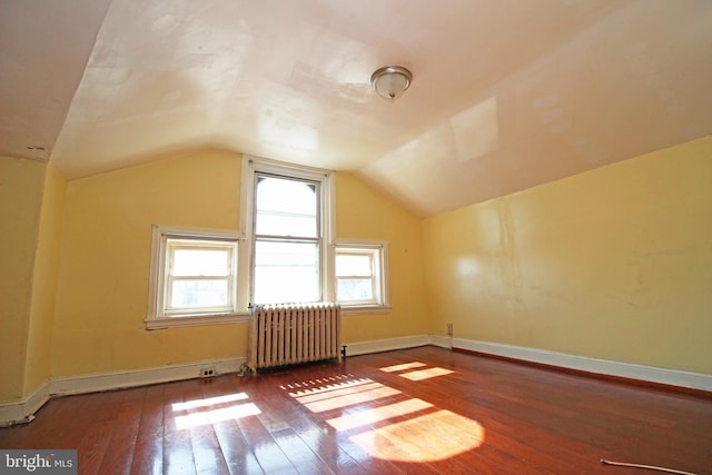 bonus room with radiator, baseboards, hardwood / wood-style floors, and lofted ceiling