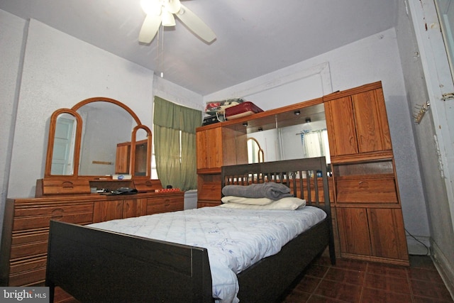 bedroom with lofted ceiling and dark tile patterned floors