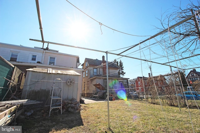 view of yard featuring a storage shed, an outdoor structure, and fence