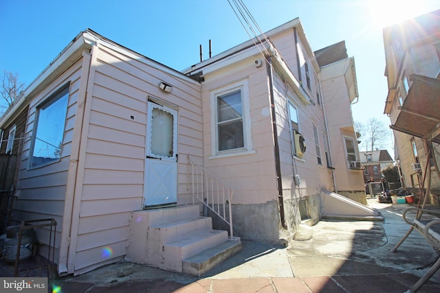 back of property featuring entry steps