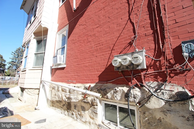 view of home's exterior featuring cooling unit and brick siding