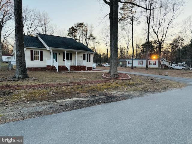 view of front of home featuring a porch and roof with shingles