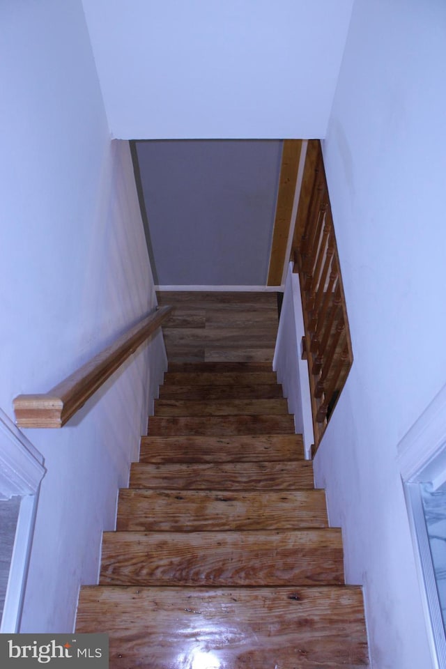 stairway featuring wood finished floors