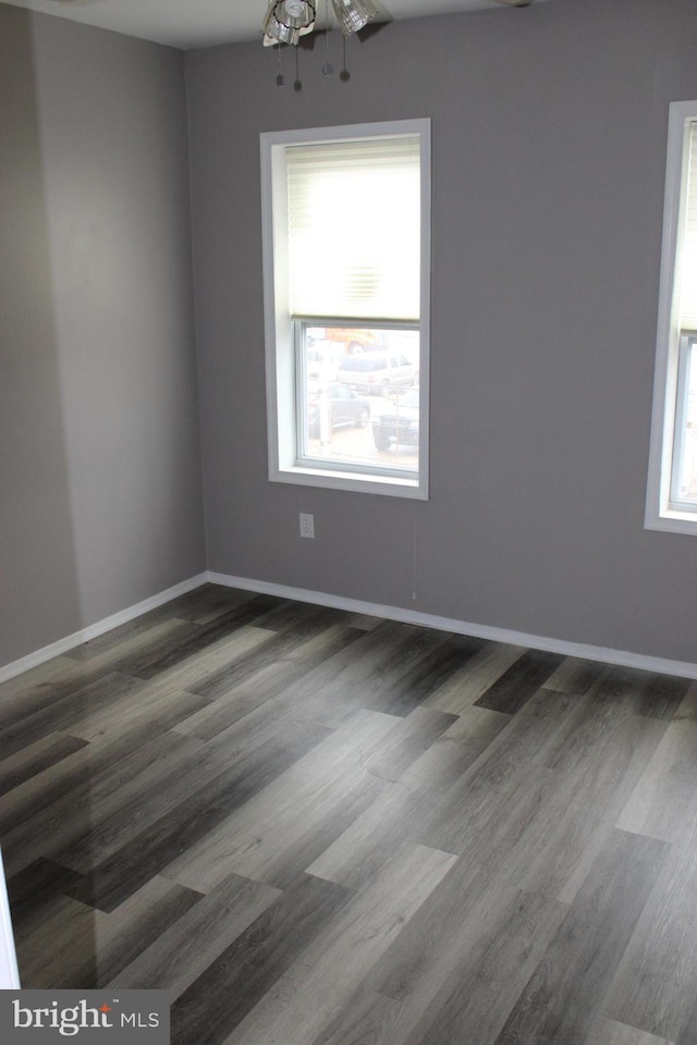 empty room featuring baseboards and wood finished floors