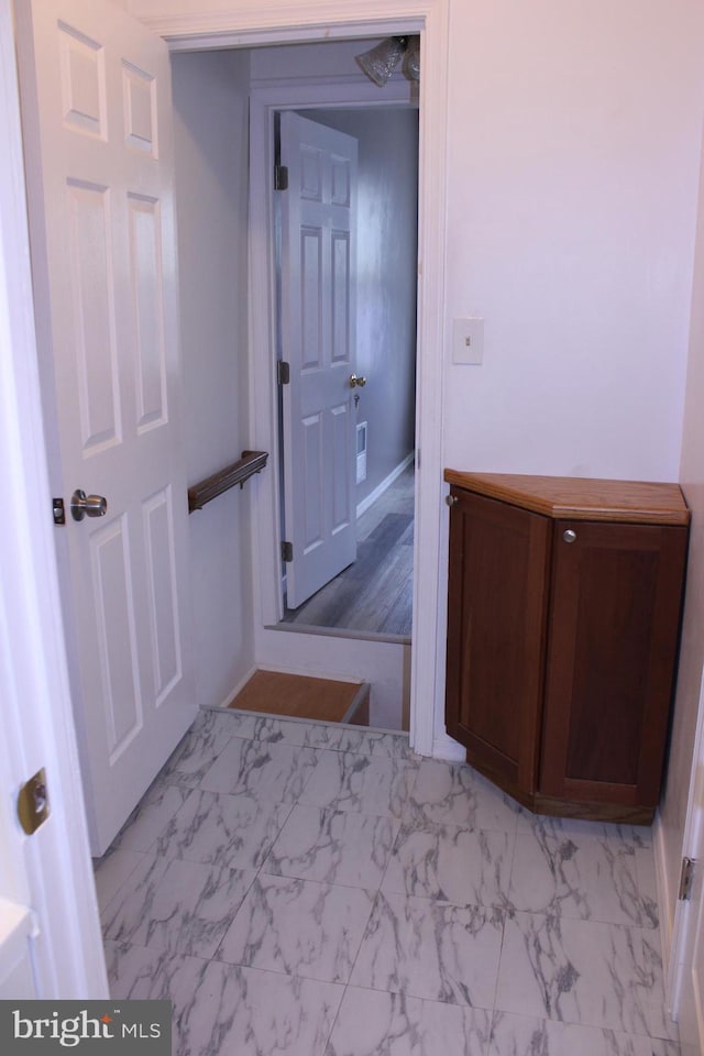 corridor with marble finish floor and visible vents