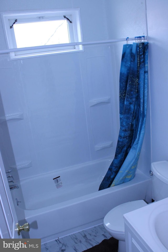 bathroom featuring vanity, shower / bath combo with shower curtain, and toilet