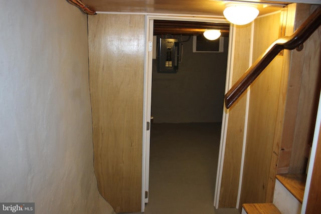 basement featuring stairs and electric panel