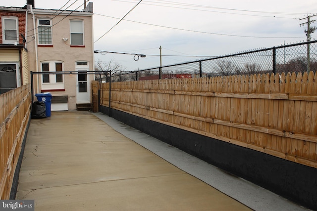 exterior space featuring fence and stucco siding