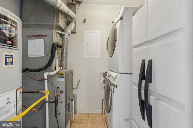 clothes washing area featuring light tile patterned floors, laundry area, electric panel, stacked washer / dryer, and water heater