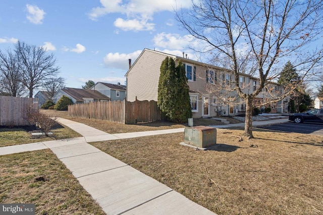 exterior space featuring a residential view and fence