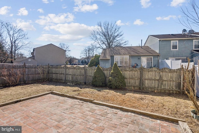 view of yard featuring a patio area and a fenced backyard