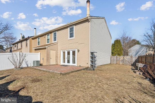 rear view of property with french doors, a patio area, and a fenced backyard