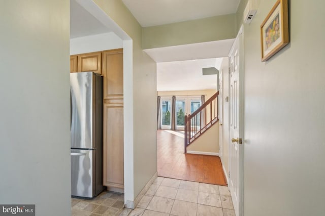 hall featuring baseboards and stairs