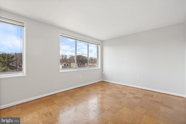 spare room featuring baseboards