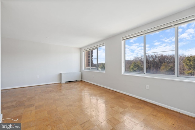 unfurnished room with baseboards