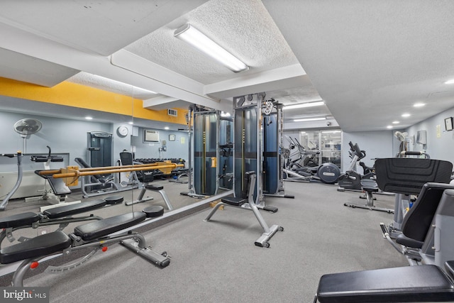 exercise room with a textured ceiling