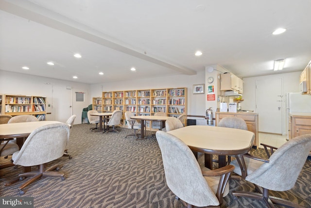 carpeted dining area with beam ceiling and recessed lighting