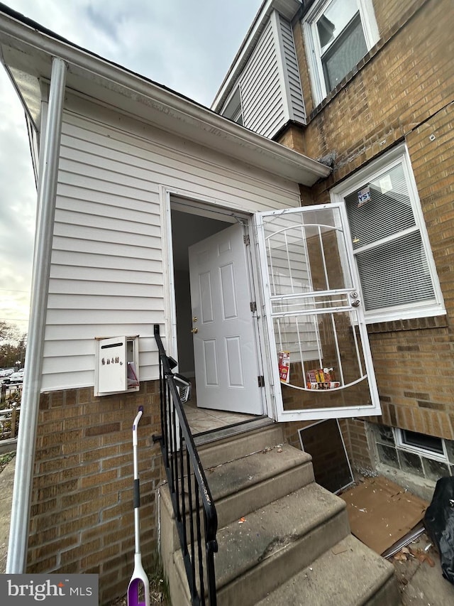 property entrance with brick siding