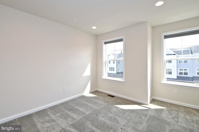 unfurnished room with recessed lighting, visible vents, baseboards, and carpet flooring