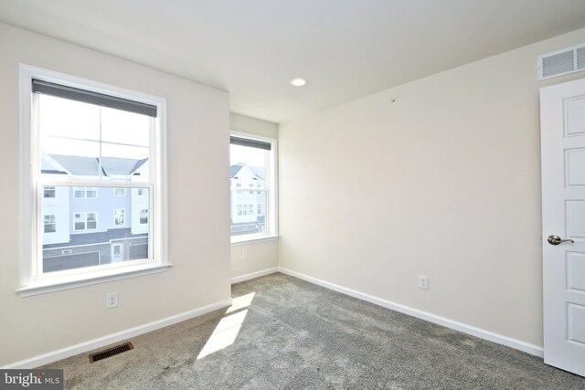 carpeted spare room with visible vents, recessed lighting, and baseboards