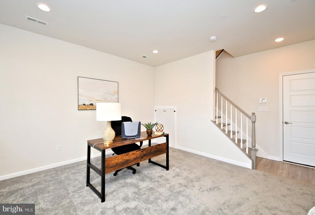 carpeted office space featuring recessed lighting, visible vents, and baseboards