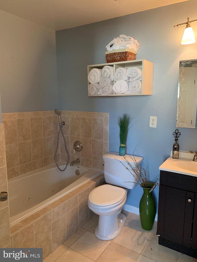 bathroom with toilet, vanity, tile patterned flooring, a whirlpool tub, and baseboards