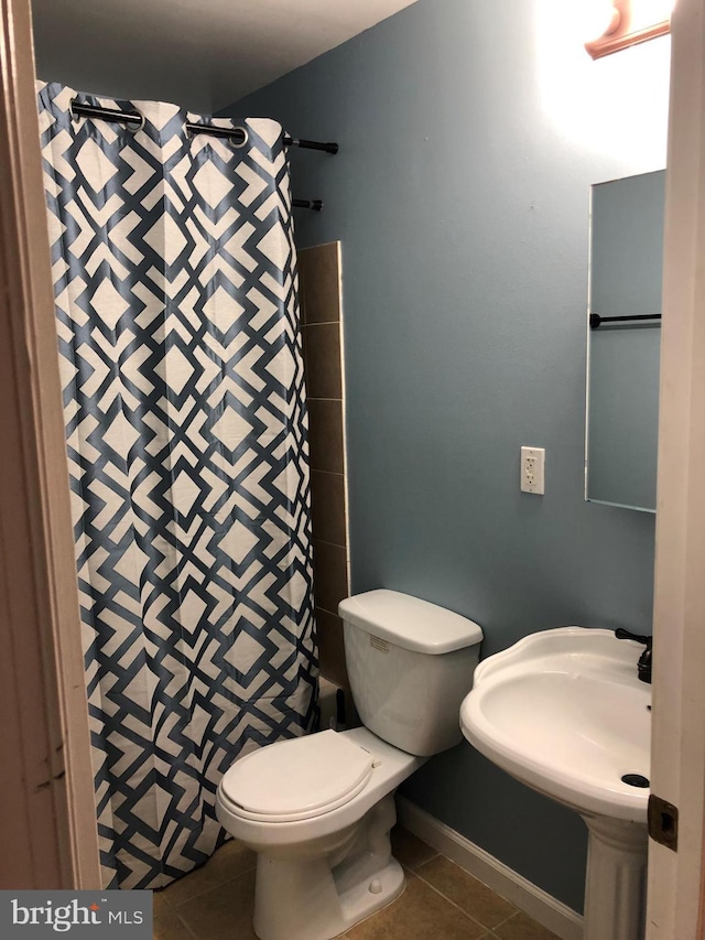 full bathroom with toilet, a shower with curtain, and tile patterned flooring