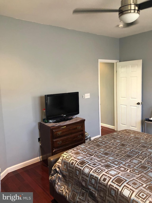 bedroom with ceiling fan, baseboards, and wood finished floors