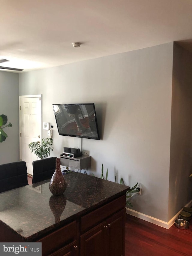 interior space with dark wood finished floors and baseboards