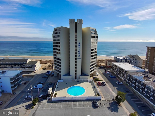 exterior space featuring a water view and a beach view