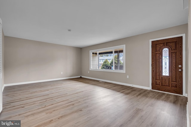 entryway featuring wood finished floors and baseboards