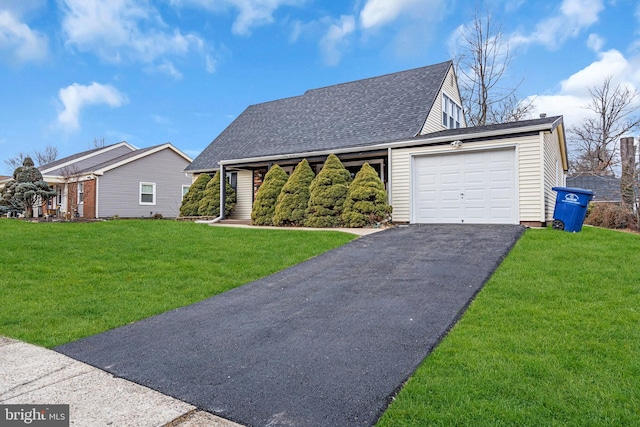 view of front of home featuring a garage, driveway, a shingled roof, and a front yard