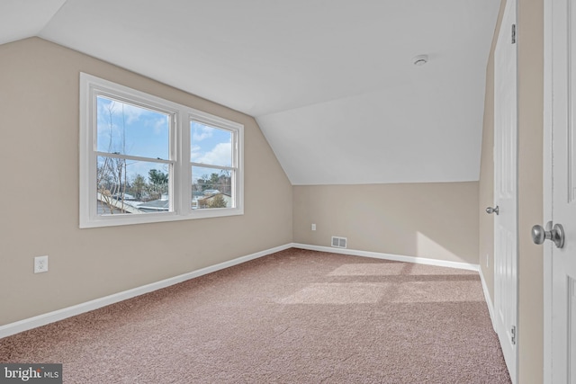 bonus room featuring carpet, visible vents, vaulted ceiling, and baseboards