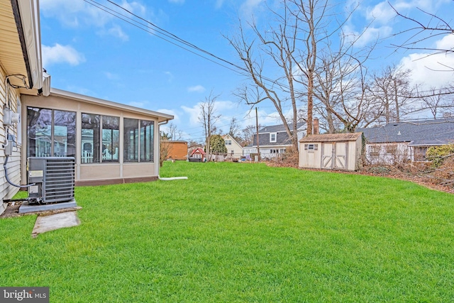 view of yard featuring cooling unit, a sunroom, an outbuilding, and a storage shed