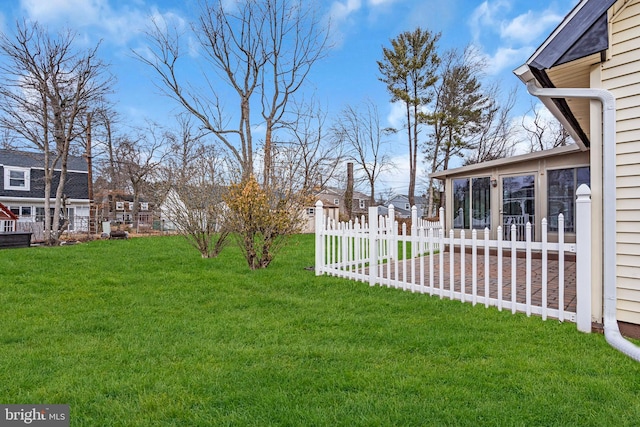 view of yard with a sunroom, a patio area, and fence