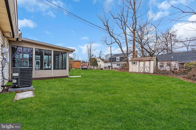 view of yard featuring a storage unit, an outdoor structure, a sunroom, and central air condition unit