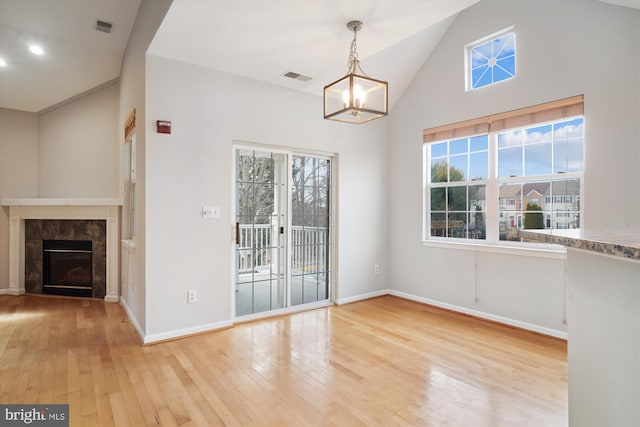 unfurnished dining area with a wealth of natural light, hardwood / wood-style floors, and visible vents