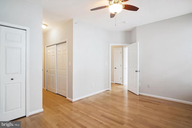 unfurnished bedroom featuring light wood-style flooring, baseboards, and ceiling fan